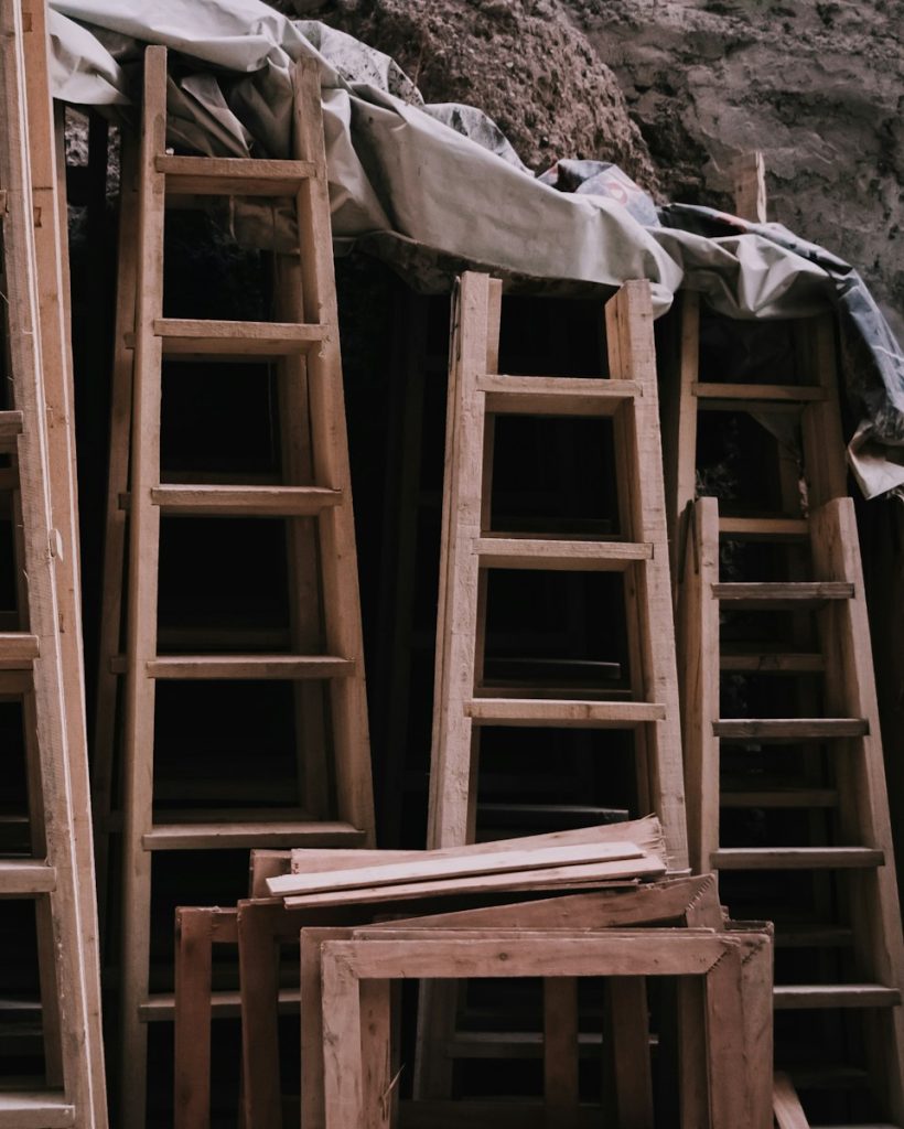 a pile of wooden ladders sitting next to each other